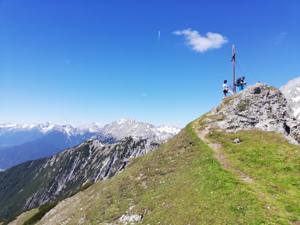 The summit cross with the Bavarian Alps visible behind.