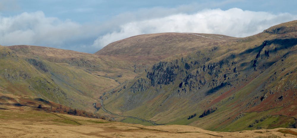 The tarmac ends at Sadgill but the old track continues below Buckbarrow Crag to climb to Gatescarth Pass