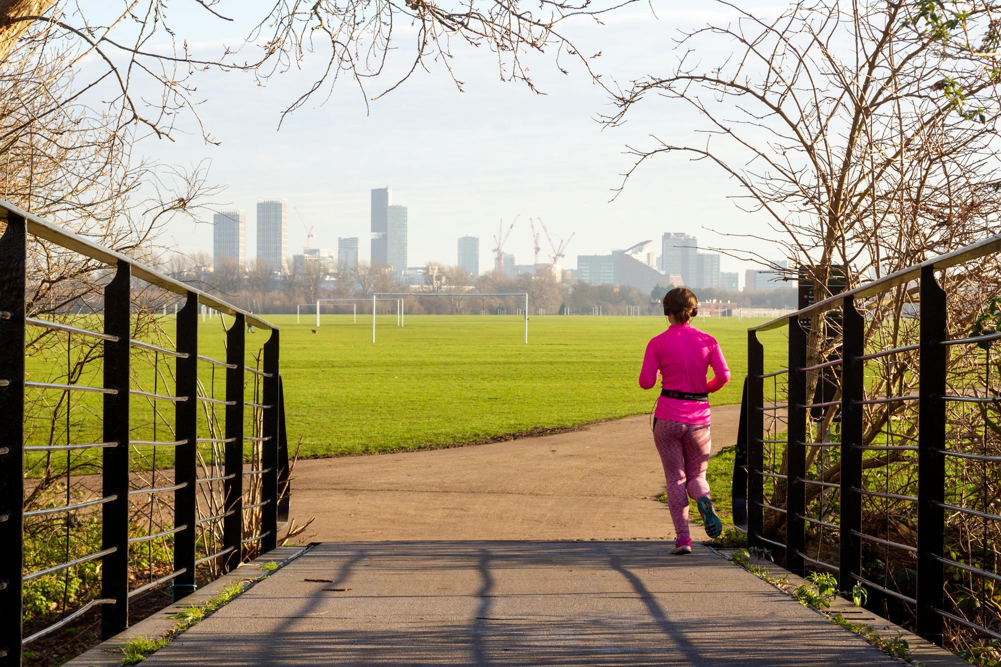 Jogging in Hackney Marshes with the London skyline behind