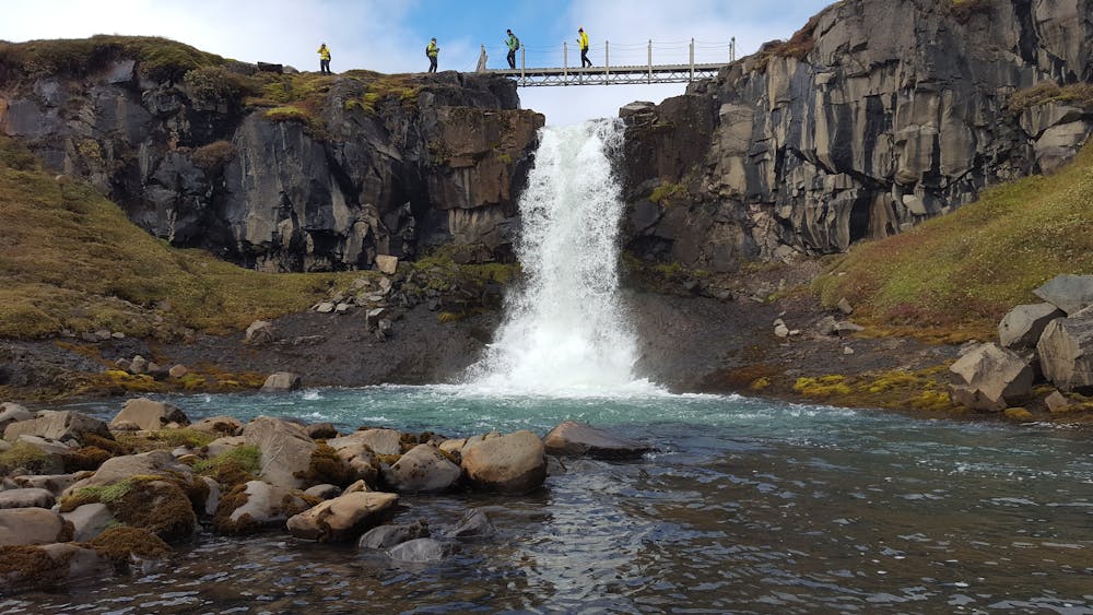 Hiking bridge over small waterfall