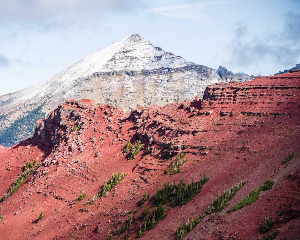 Snow capped peak and colorful ridges await you on the far side of the tunnel.