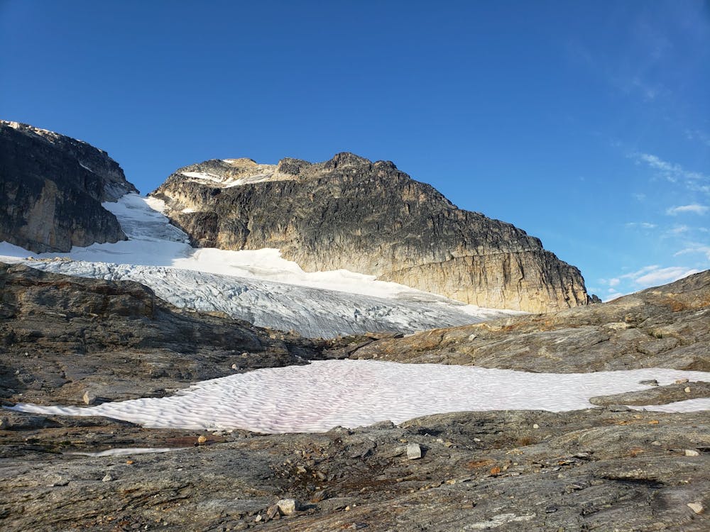 Looking up at Begbie from just below the glacier. The route goes up the glacier, rightwards along the horizontal ledge and onto the righthand skyline.