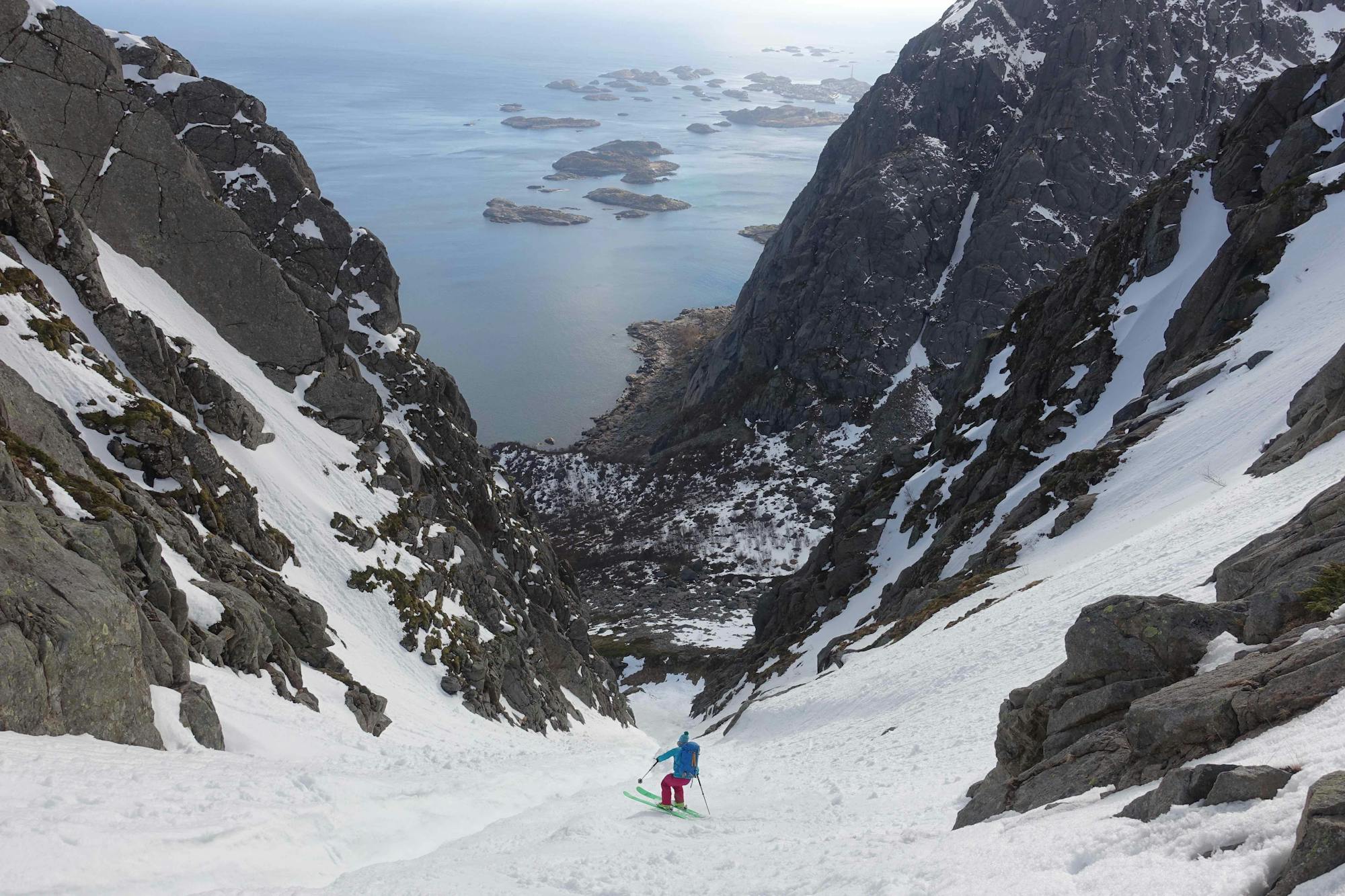 Skiing above the coast; magnificent Lofoten couloir skiing.