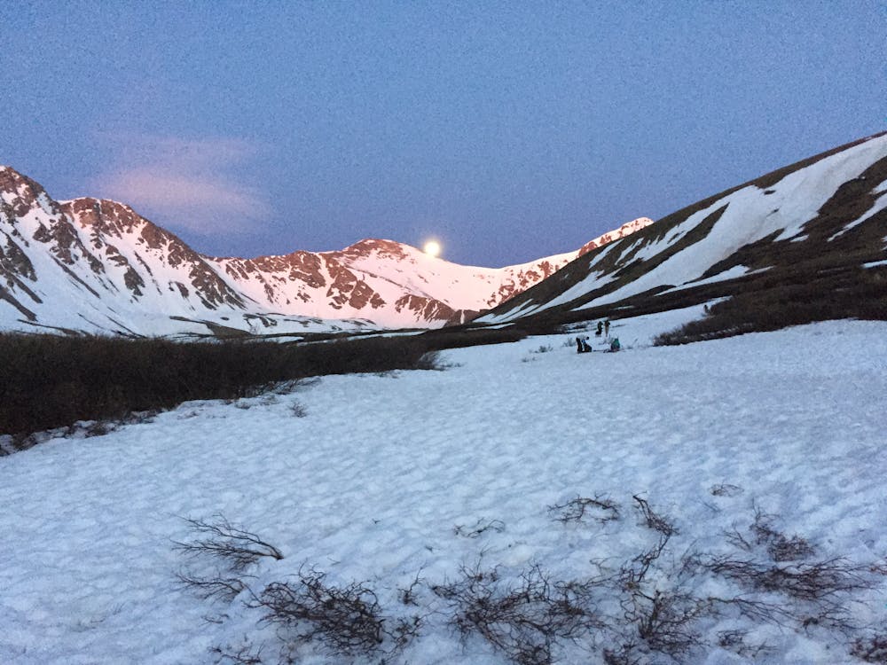 Looking up the valley with Grays Peak to the left of the moon and Lost Rat Couloir below that to the left.