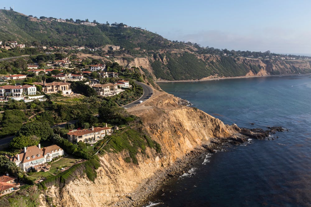 Coastal aerial view of ocean bluffs and homes in the Rancho Palos Verdes area 