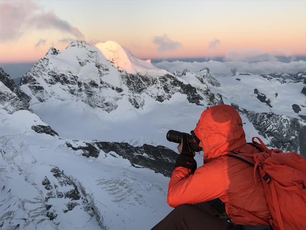 Ben Tibbetts taking dawn shots of the Biancograt from the summit of Piz Morteratsch