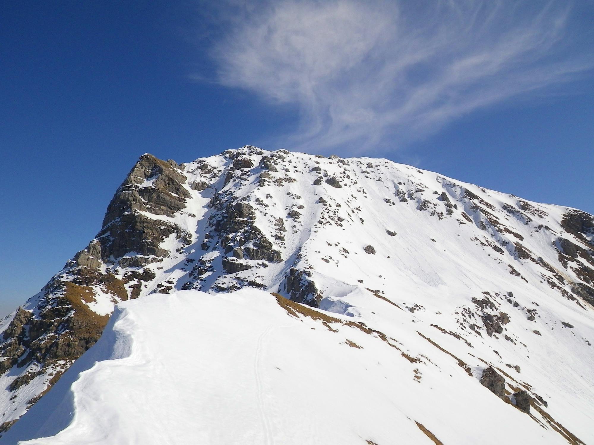Looking up at the summit from the west ridge. The Petit Pertuis is the line directly down from the little col right of the summit.
