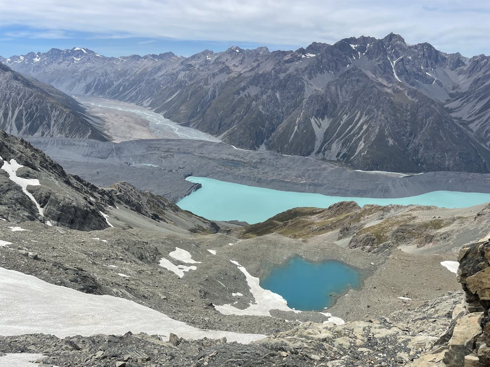 Alpine tarn below Mabel Col. Tasman Glacier Lake and Murchison Valley in the background.