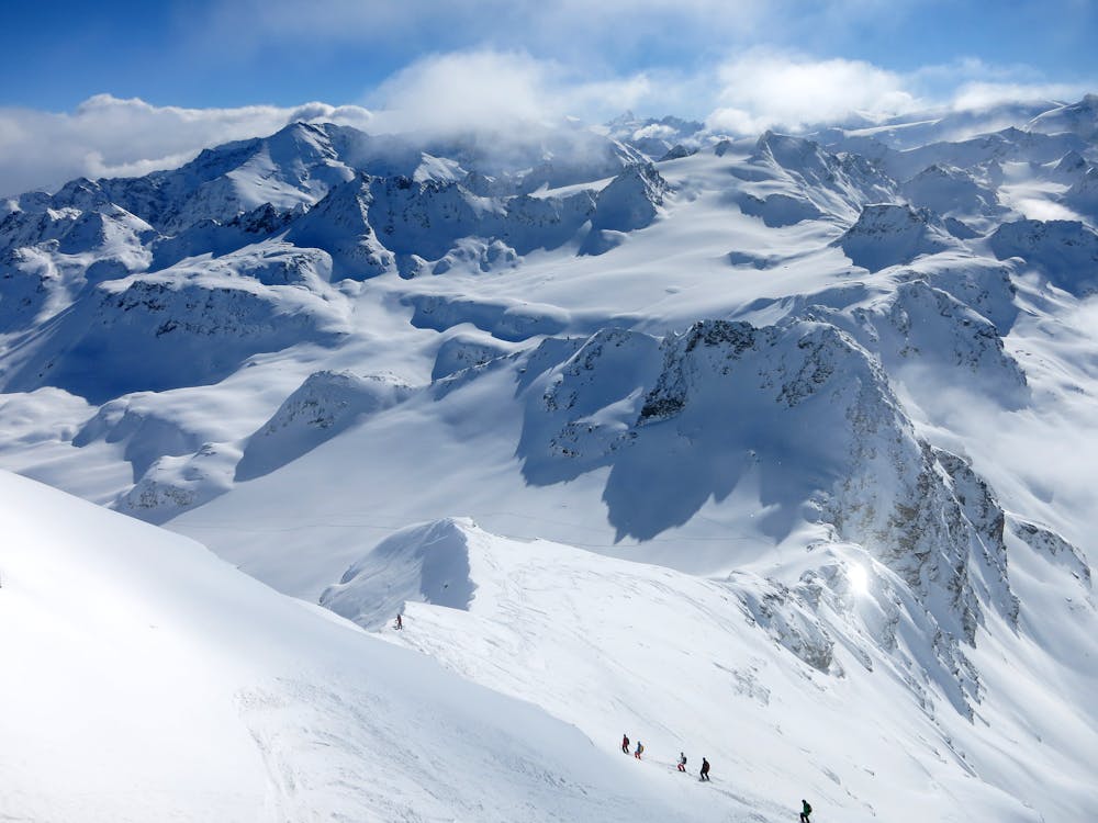 Skiers descend the backside of Mont Fort, Verbier, Valais
