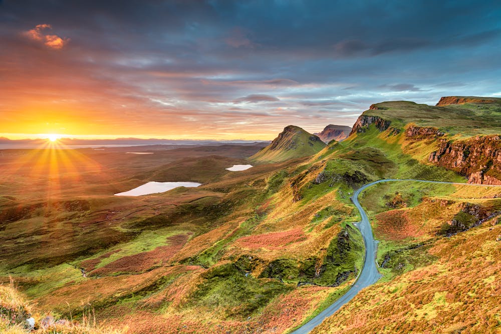 Beautiful Autumn sunrise over the Quiraing and its steep winding mountain road