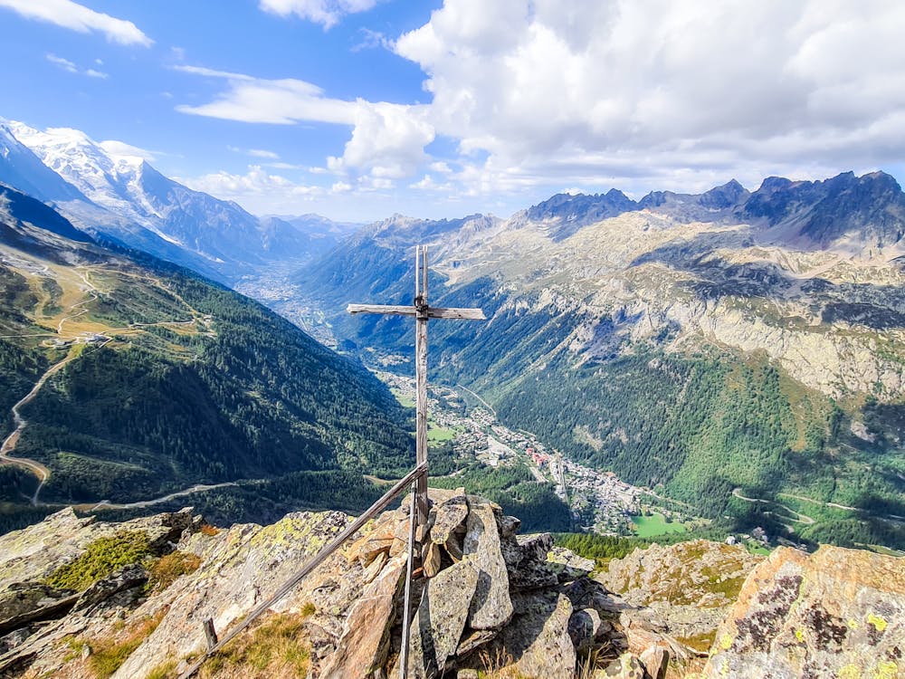 Alternative view of summit cross with Argentiere and Chamonix in the background.