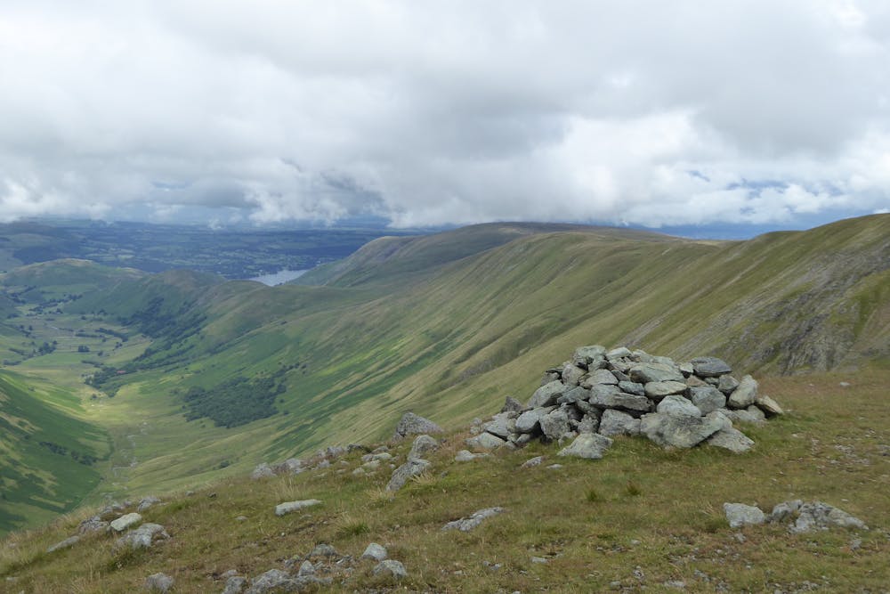 Cairn at the edge of Rampsgill Head. High Raise, Loadpot Hill and Wether Hill in the distance.