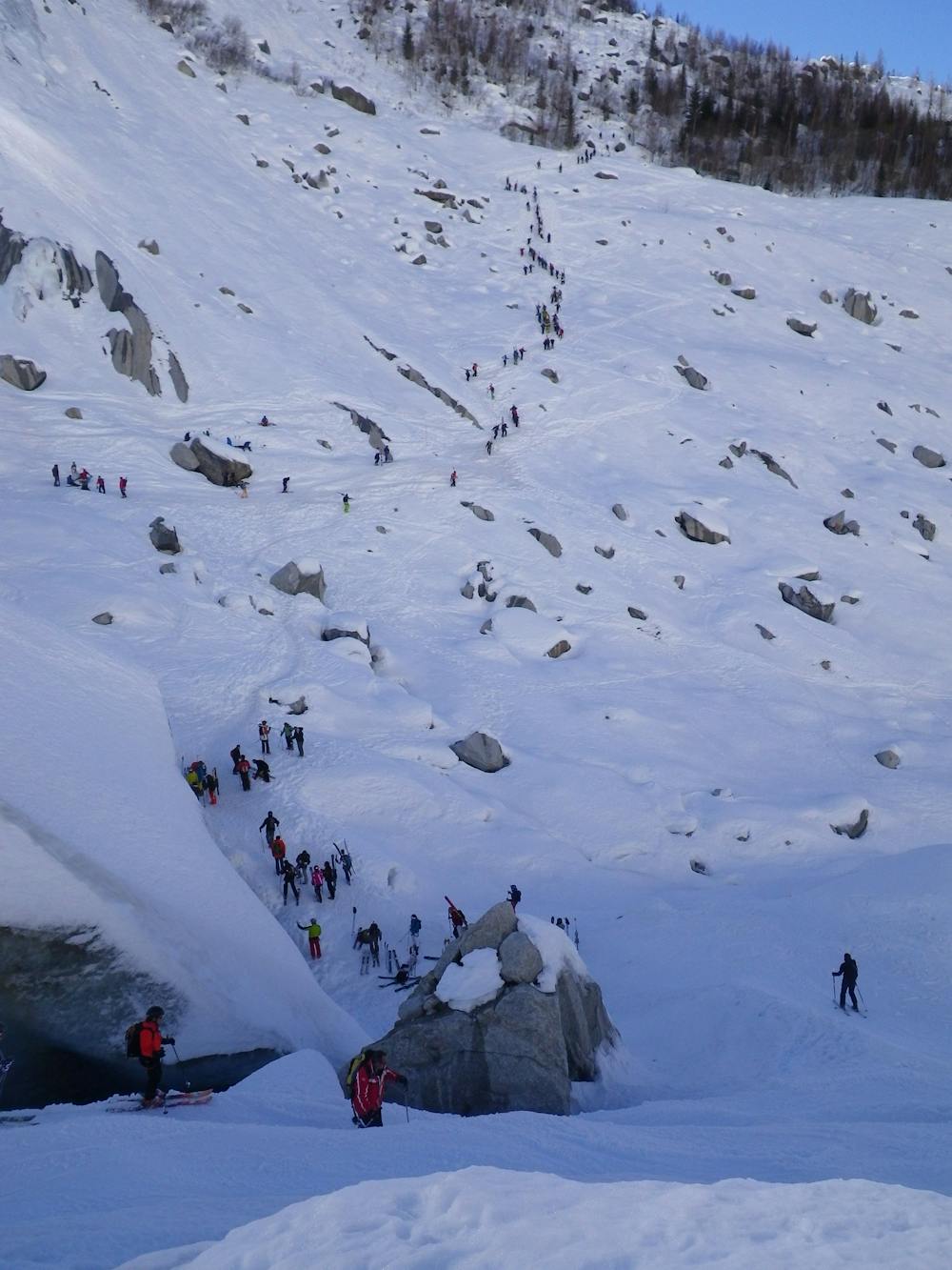 Skiers beginning the hike up to the start of the James Bond Track from the end of the Vallée Blanche