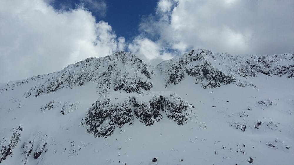 The face with the line on the left of the peak.