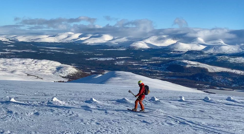 Heading back down from the summit with the Cairngorms in the distance