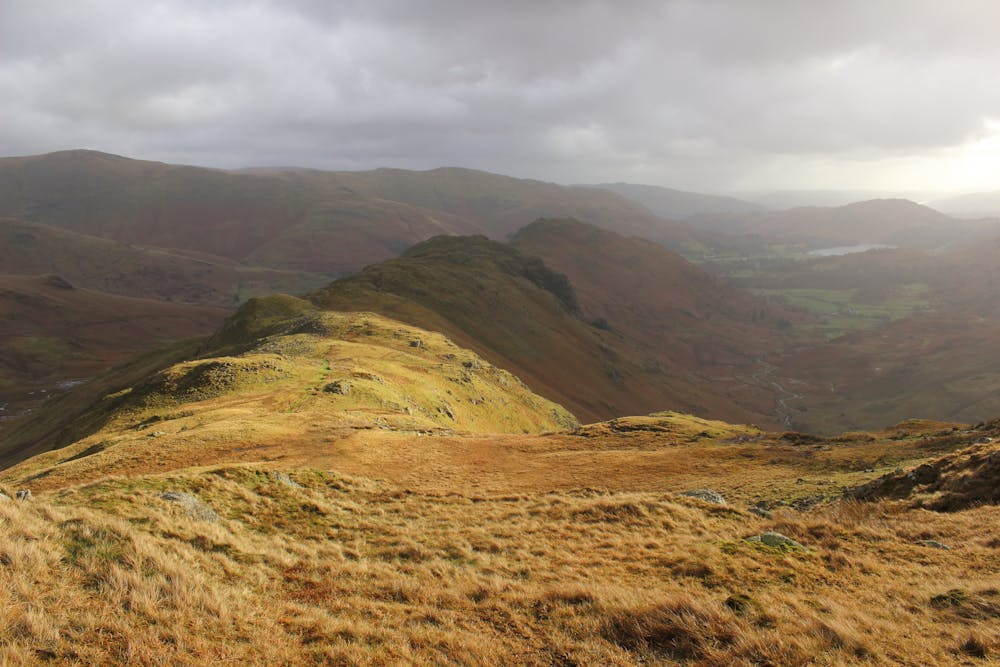 Gibson Knott and Helm Crag as the sun briefly beats the clouds. 